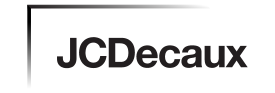 Black text reads JCDecaux in bold, sans-serif font on a white background. A thin black line extends horizontally above the text, with a corner on the top left, fading to grey toward the top right—a clean, minimalist look suited for video production Sydney brands.